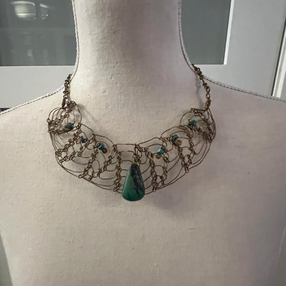 necklace of golden metal threads with natural jade-colored